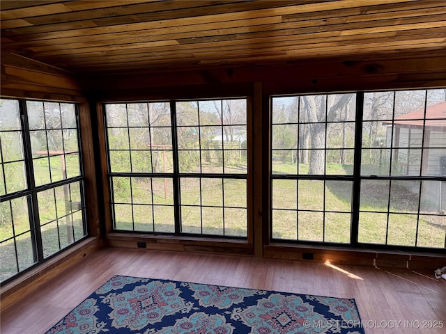 unfurnished sunroom with wood ceiling