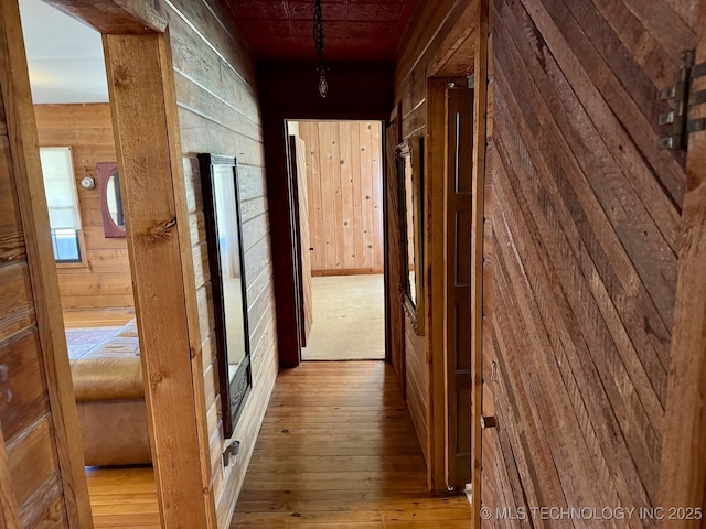 707 E 15th St, Okmulgee, OK 74447 - hall with hardwood / wood-style flooring and wooden walls