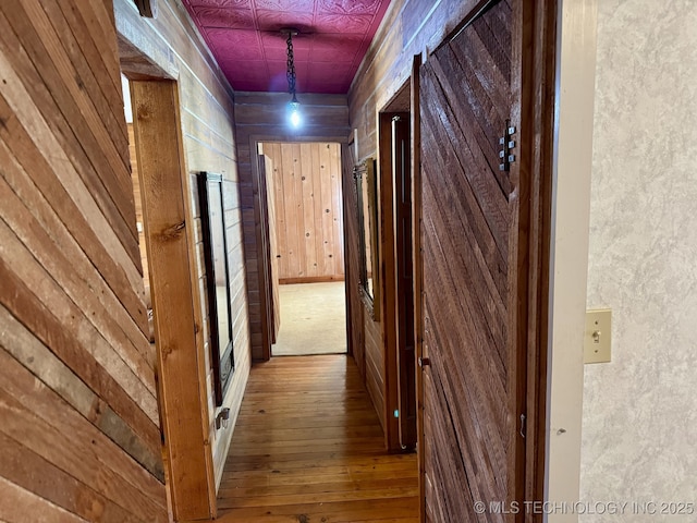 707 E 15th St, Okmulgee, OK 74447 - hallway with hardwood / wood-style floors and wood walls