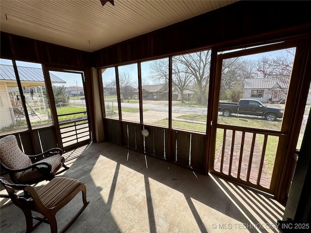 sunroom / solarium featuring a residential view