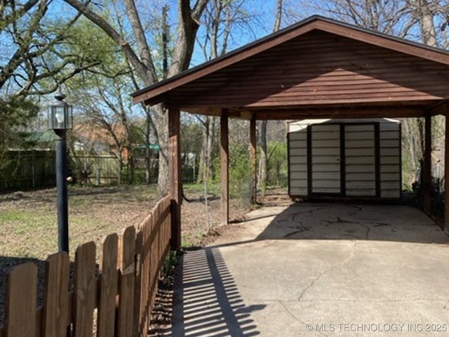 707 E 15th St, Okmulgee, OK 74447 - view of patio with a carport and driveway