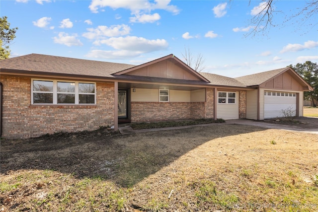 ranch-style home featuring aphalt driveway, a garage, brick siding, and a shingled roof