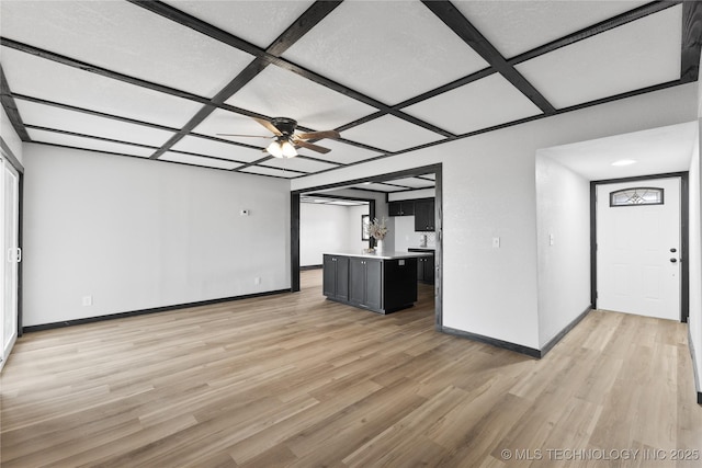 unfurnished living room featuring light wood-type flooring, baseboards, and coffered ceiling