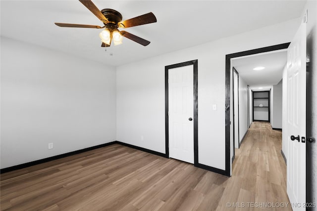 unfurnished bedroom with baseboards, light wood-type flooring, and ceiling fan