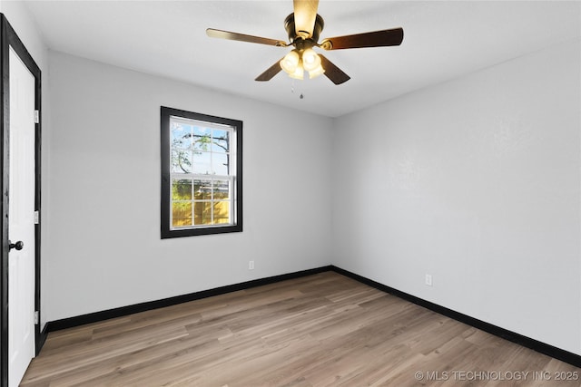 spare room featuring baseboards, light wood-style floors, and ceiling fan