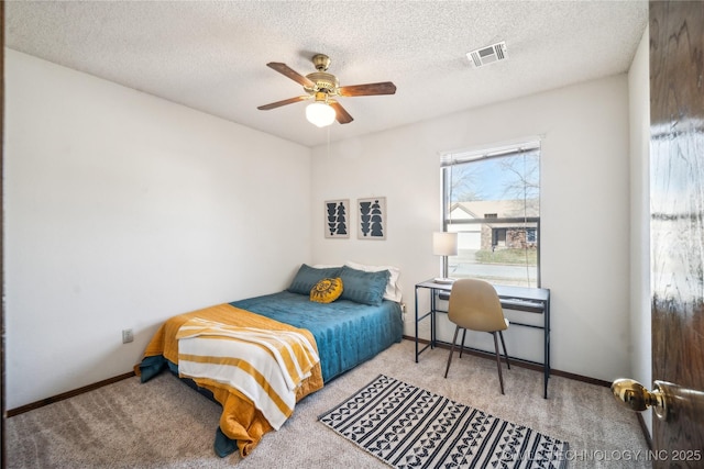 bedroom with baseboards, visible vents, carpet floors, and a textured ceiling