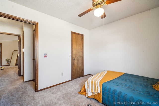 carpeted bedroom with baseboards, a textured ceiling, and ceiling fan