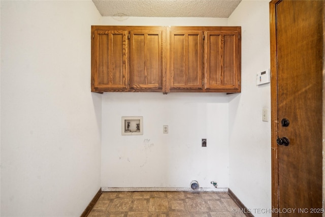 washroom featuring baseboards, cabinet space, hookup for an electric dryer, and hookup for a washing machine