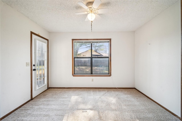 unfurnished room featuring baseboards, carpet flooring, a textured ceiling, and a ceiling fan