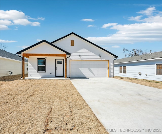 view of front of house featuring driveway and a garage