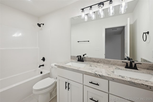 bathroom featuring double vanity, toilet, shower / bathtub combination, and a sink