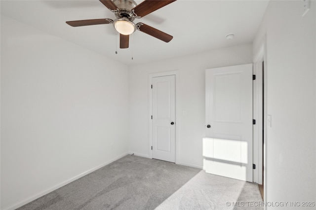 unfurnished bedroom featuring baseboards, carpet floors, and ceiling fan