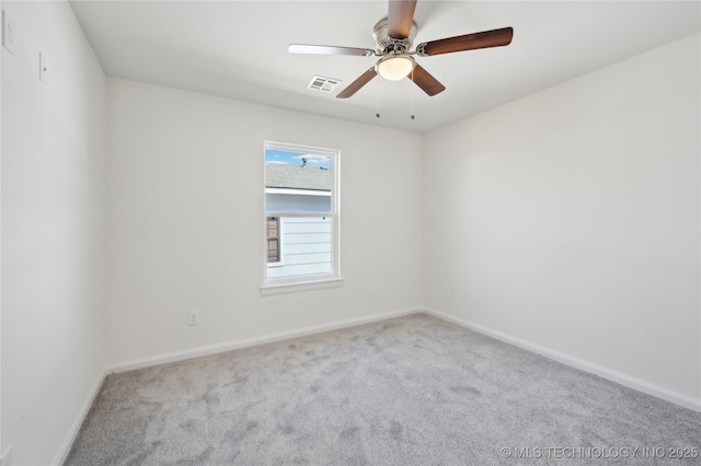 carpeted empty room featuring visible vents, baseboards, and a ceiling fan