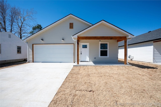 view of front facade featuring a garage, a porch, and driveway