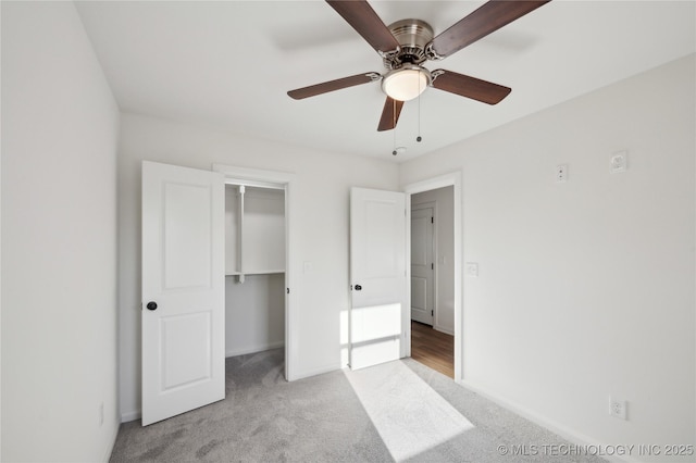 unfurnished bedroom with baseboards, light carpet, a closet, and ceiling fan