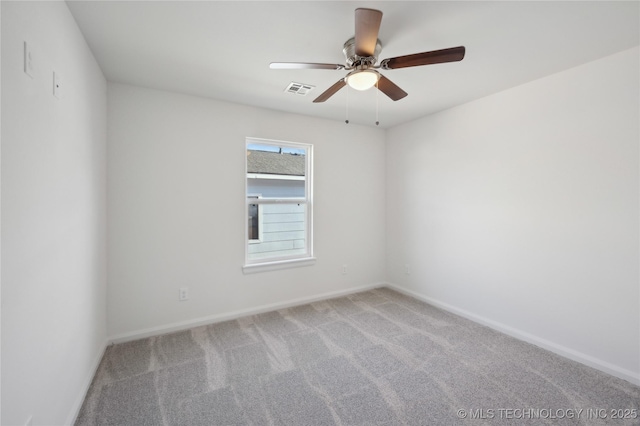 carpeted empty room featuring visible vents, baseboards, and a ceiling fan