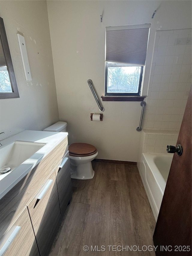 full bathroom featuring vanity, toilet, and wood finished floors