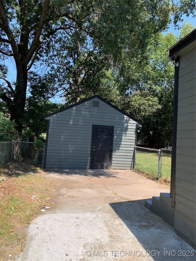 view of shed featuring fence