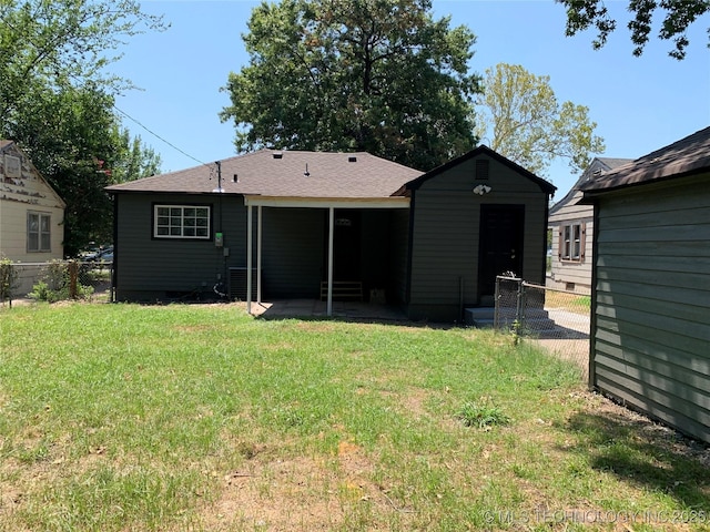 back of property featuring a patio, a yard, and fence