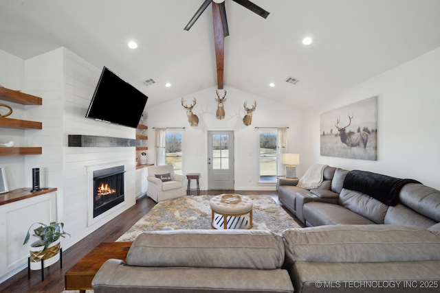 living room with visible vents, a fireplace, lofted ceiling with beams, and dark wood-type flooring