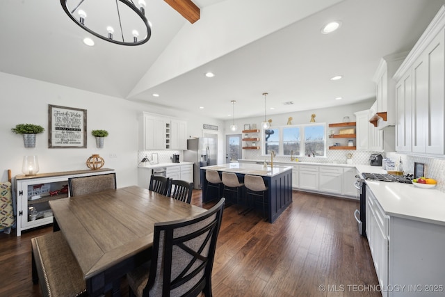 dining space featuring dark wood finished floors, a notable chandelier, recessed lighting, and lofted ceiling with beams