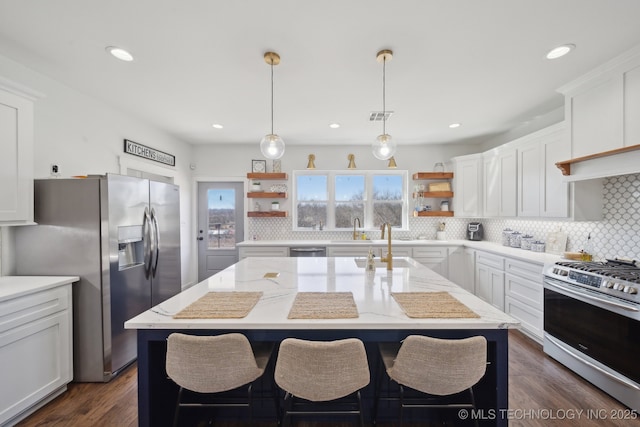 kitchen with visible vents, white cabinets, stainless steel appliances, and open shelves