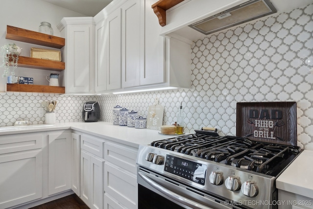 kitchen with ventilation hood, open shelves, light countertops, white cabinets, and stainless steel gas stove