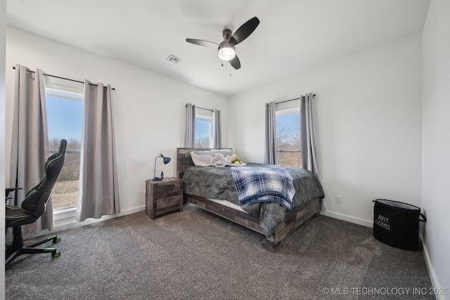 bedroom with dark colored carpet, visible vents, baseboards, and ceiling fan