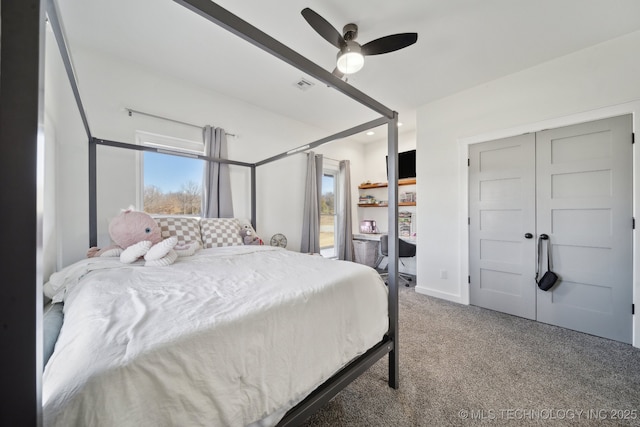 carpeted bedroom featuring visible vents, baseboards, and ceiling fan