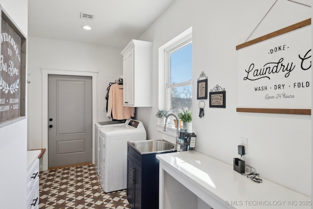 laundry area with visible vents, cabinet space, a sink, tile patterned floors, and washer and clothes dryer