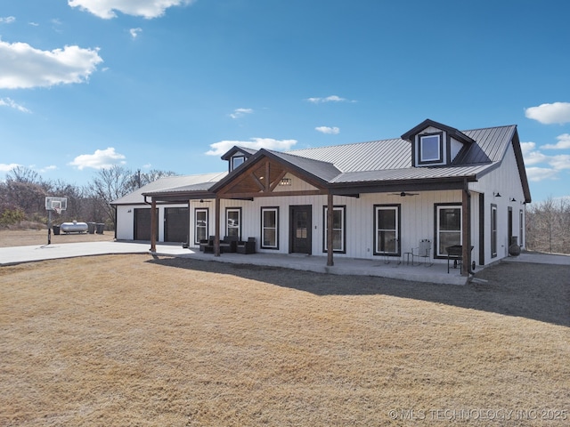 view of front of house featuring a garage, metal roof, concrete driveway, and a ceiling fan