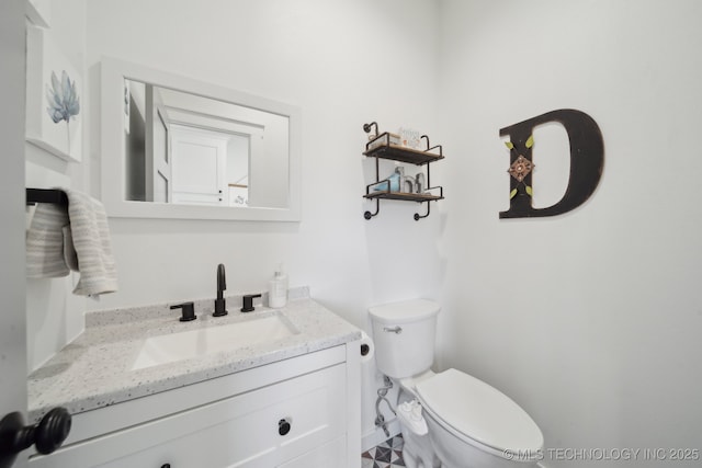 bathroom featuring toilet and vanity