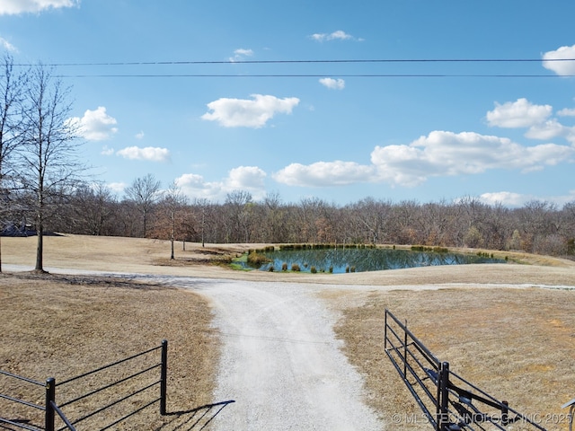 exterior space featuring a forest view and a water view