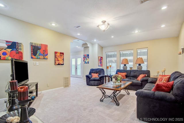 living room with visible vents, baseboards, recessed lighting, french doors, and light carpet