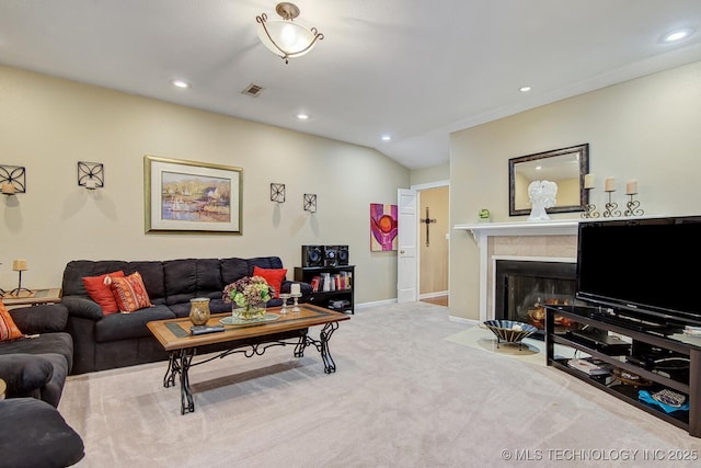 living room featuring a fireplace with flush hearth, recessed lighting, visible vents, and carpet floors