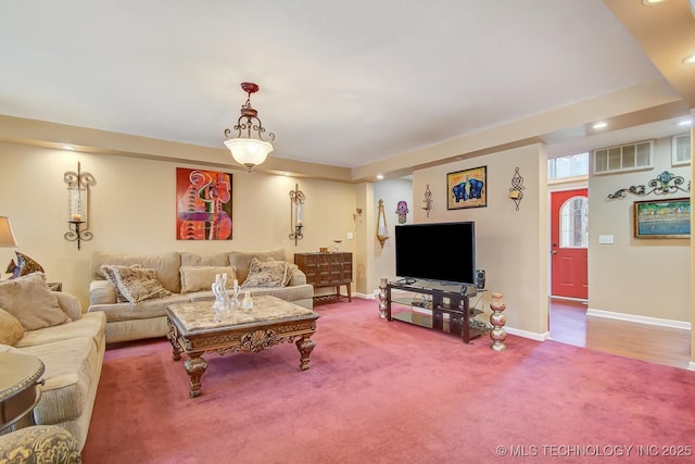 carpeted living area with recessed lighting, baseboards, and visible vents