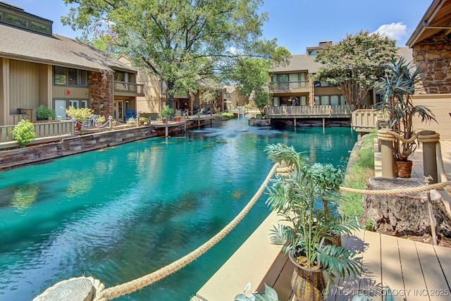 view of pool featuring a water view