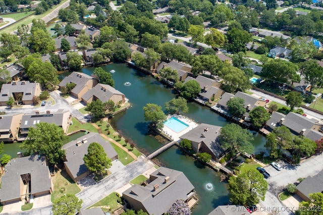 drone / aerial view with a residential view and a water view