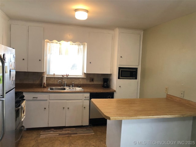 kitchen with built in microwave, freestanding refrigerator, a sink, white cabinets, and dishwasher