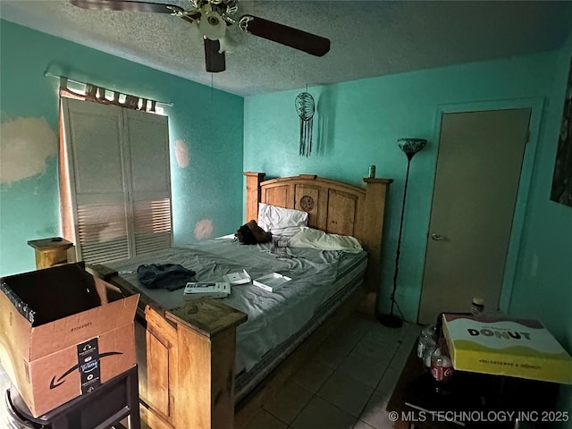 3730 Governor Harris St, Ada, OK 74820 - tiled bedroom featuring ceiling fan and a textured ceiling