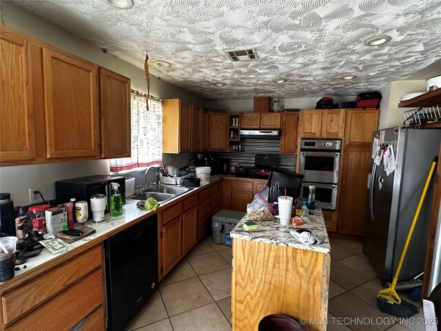 3730 Governor Harris St, Ada, OK 74820 - kitchen featuring visible vents, a sink, a center island, stainless steel appliances, and light tile patterned flooring