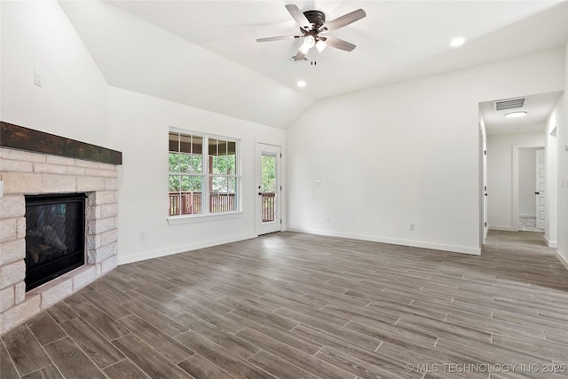 7423 W 39th St, Tulsa, OK 74107 - unfurnished living room featuring lofted ceiling, a ceiling fan, baseboards, wood finished floors, and a stone fireplace