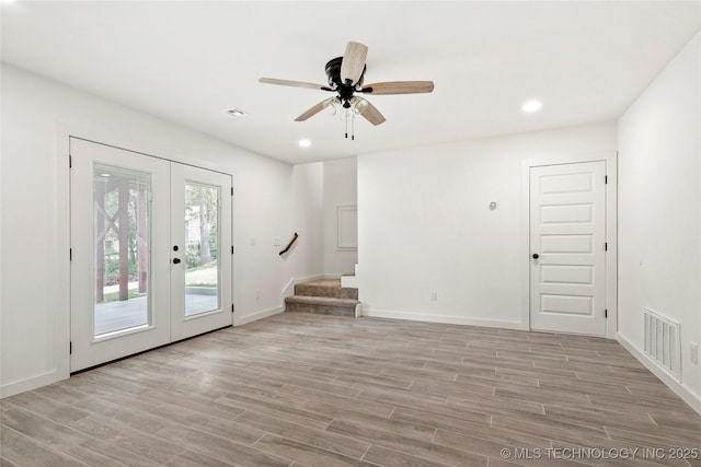 7423 W 39th St, Tulsa, OK 74107 - spare room featuring french doors, light wood-style flooring, stairs, baseboards, and recessed lighting