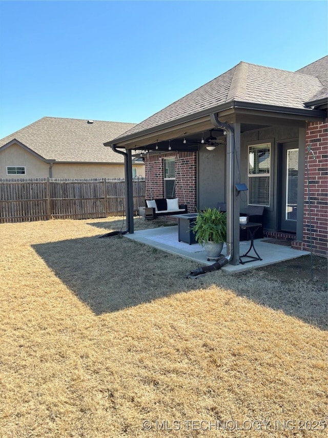 view of yard with a patio, ceiling fan, and fence