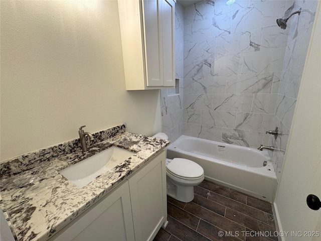 bathroom with toilet, vanity, shower / bathing tub combination, and wood tiled floor