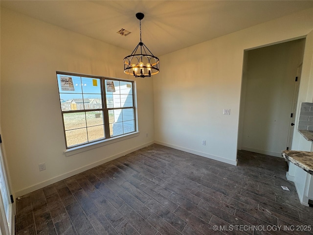 unfurnished dining area with baseboards, a notable chandelier, and dark wood-style floors