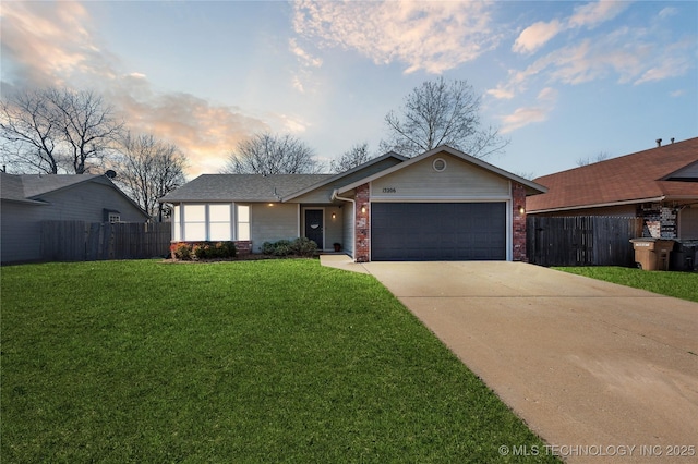 ranch-style home with concrete driveway, a yard, fence, and brick siding