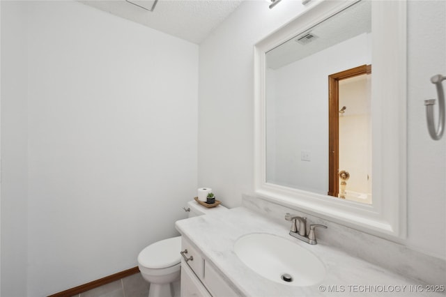 half bath featuring visible vents, toilet, vanity, tile patterned floors, and a textured ceiling