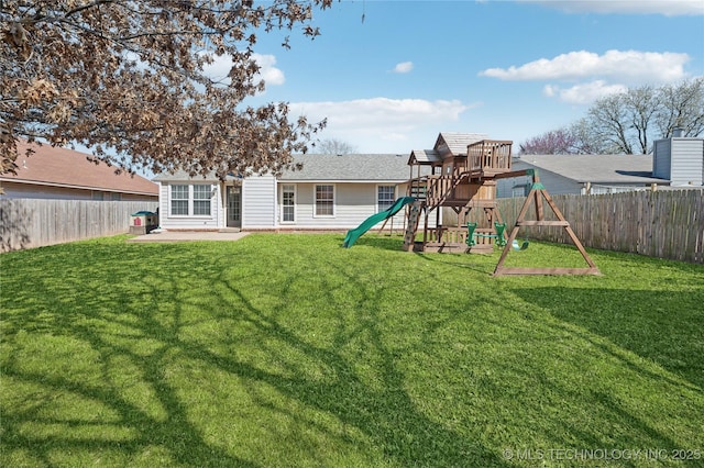 back of property featuring a lawn, a patio, a playground, and a fenced backyard