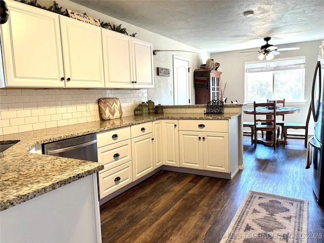 kitchen featuring a peninsula, decorative backsplash, light stone countertops, ceiling fan, and dark wood-style flooring